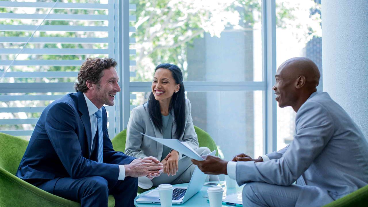 Diverse businesspeople sitting smiling