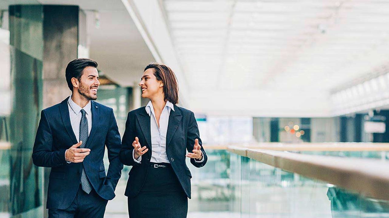 Man and woman in business attire talking