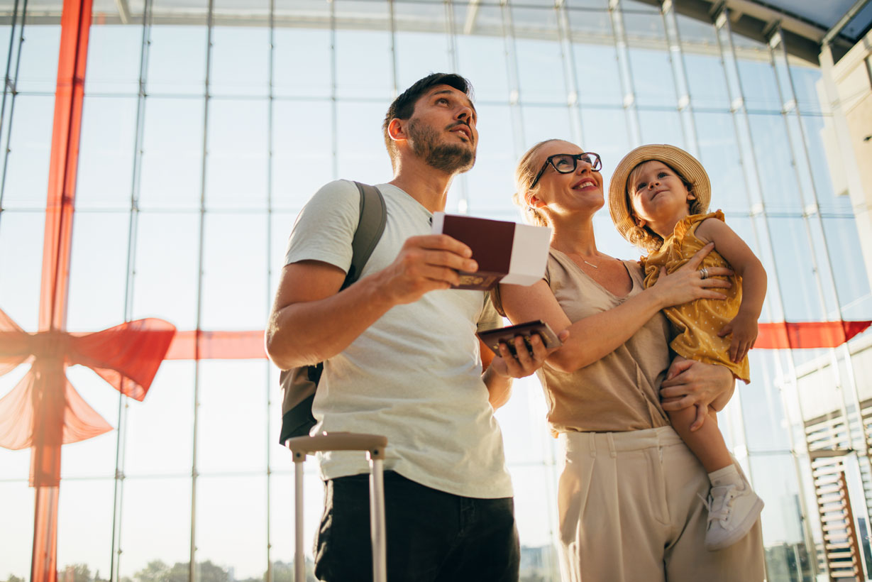 Young family standing at airport