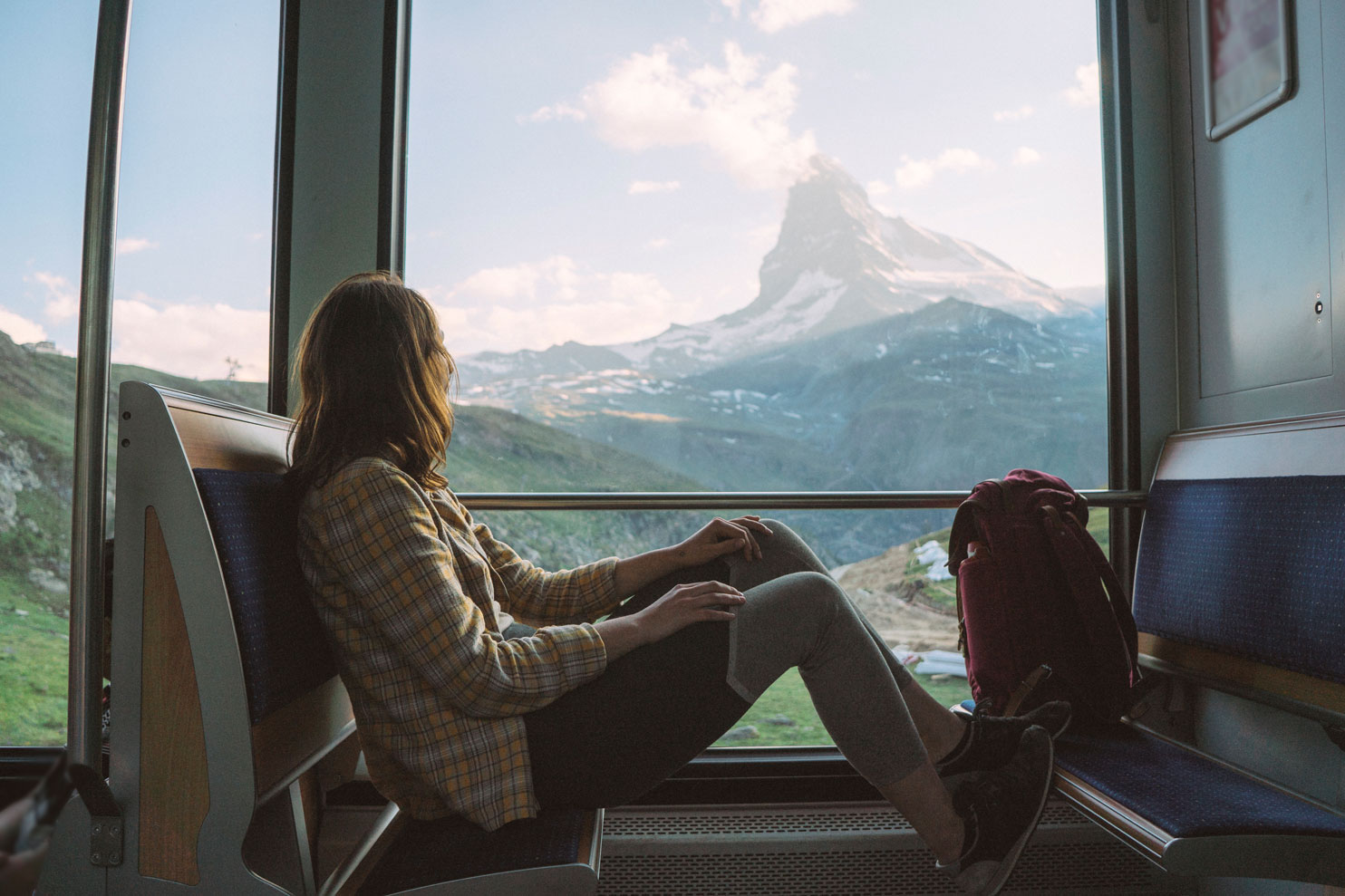 Woman looking out of a train window in a foreign country