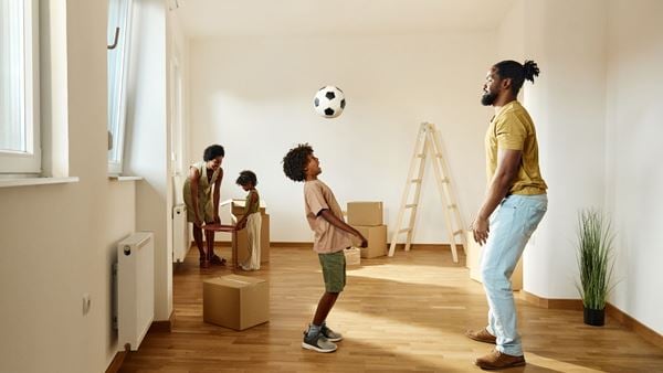 Father and on playing with football on moving day